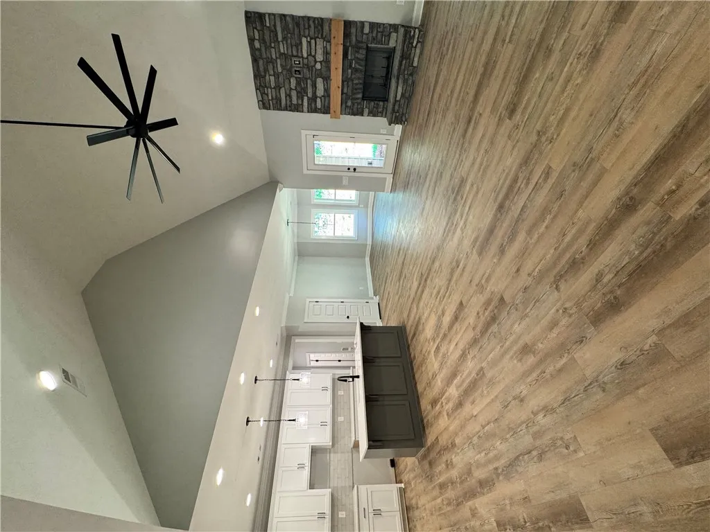 This bright and airy interior boasts soaring ceilings, inviting warmth and natural light throughout.