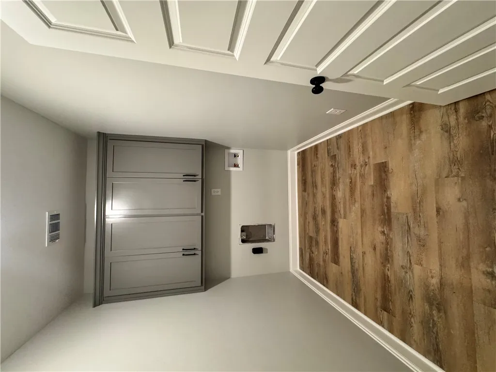 This dedicated laundry room features functional cabinetry and durable flooring.