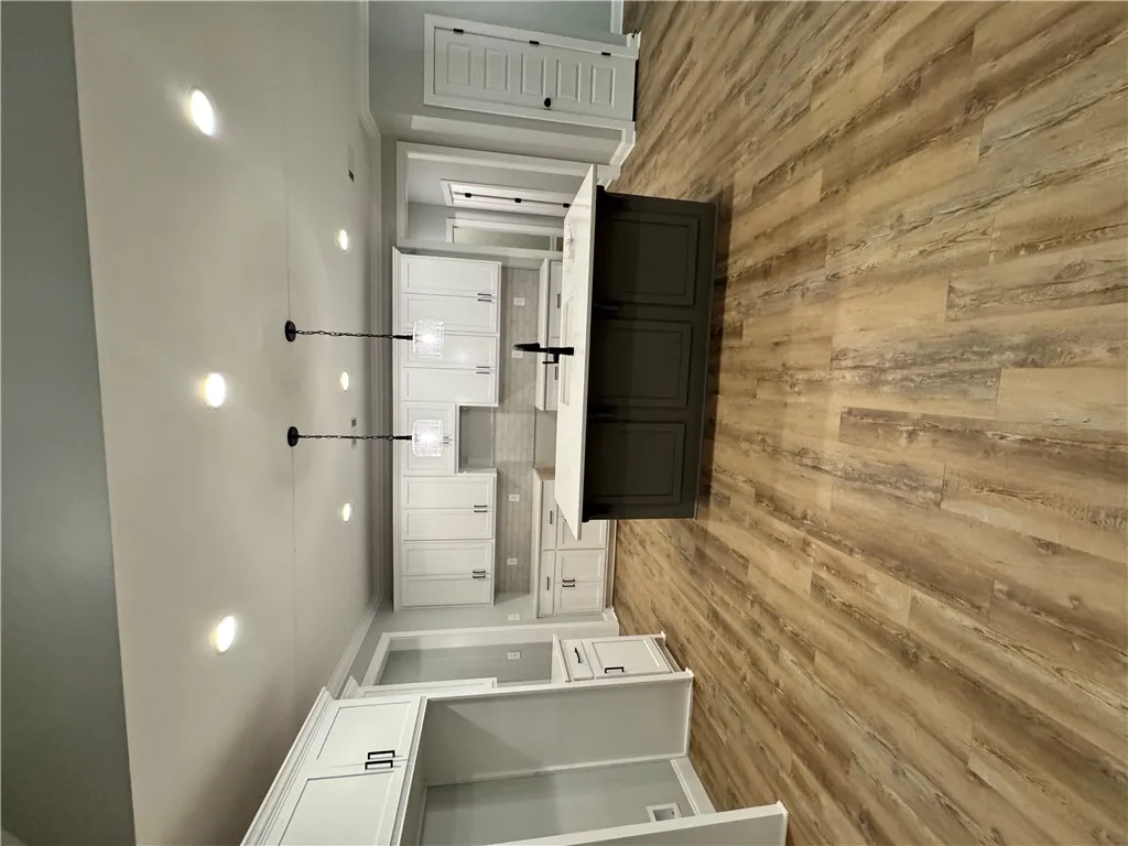 Modern kitchen with white cabinetry and an inviting island, perfect for culinary endeavors.