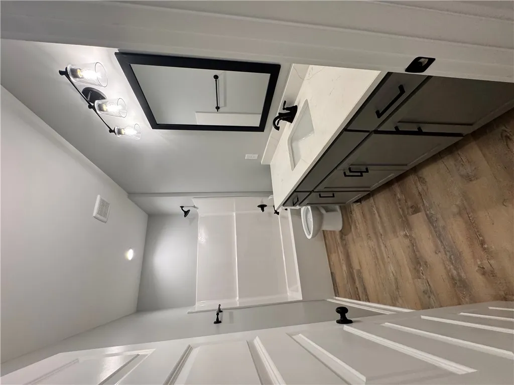 This newly renovated bathroom features modern fixtures and ample storage, providing a refreshing daily retreat.