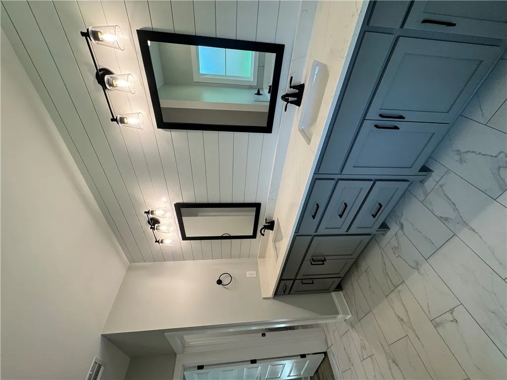 This bathroom features a double vanity and sleek modern finishes.