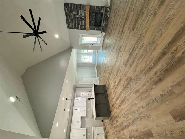 This bright and airy interior boasts soaring ceilings, inviting warmth and natural light throughout.