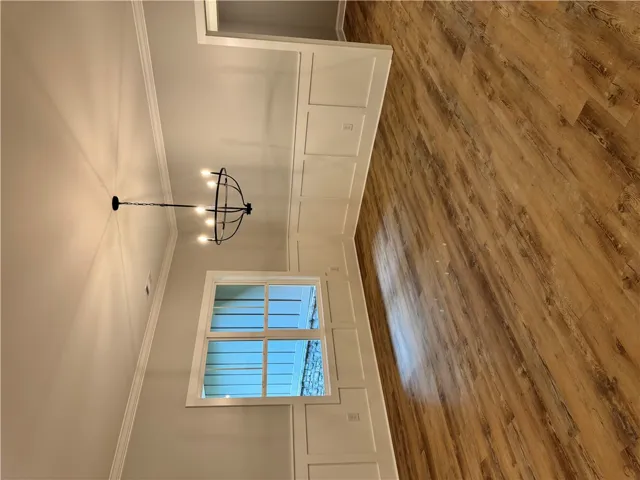 This inviting space features classic wainscoting and warm wood flooring.