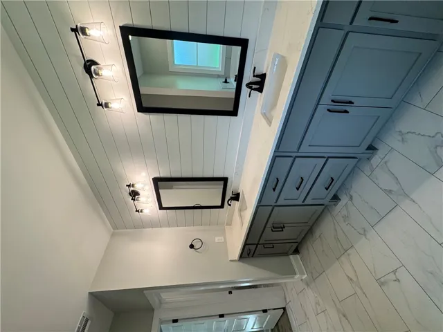 This bathroom features a double vanity and sleek modern finishes.