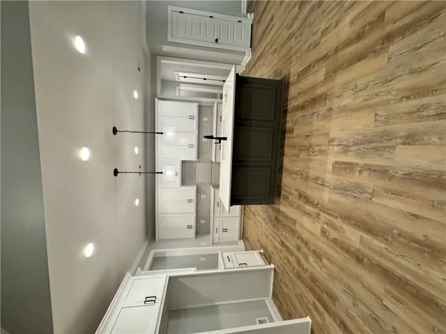 Modern kitchen with white cabinetry and an inviting island, perfect for culinary endeavors.