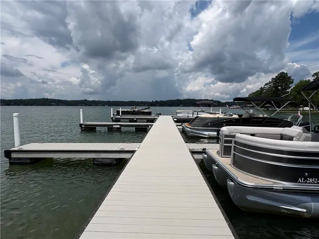A private boat dock extends into a serene lake, offering ample mooring for multiple vessels.