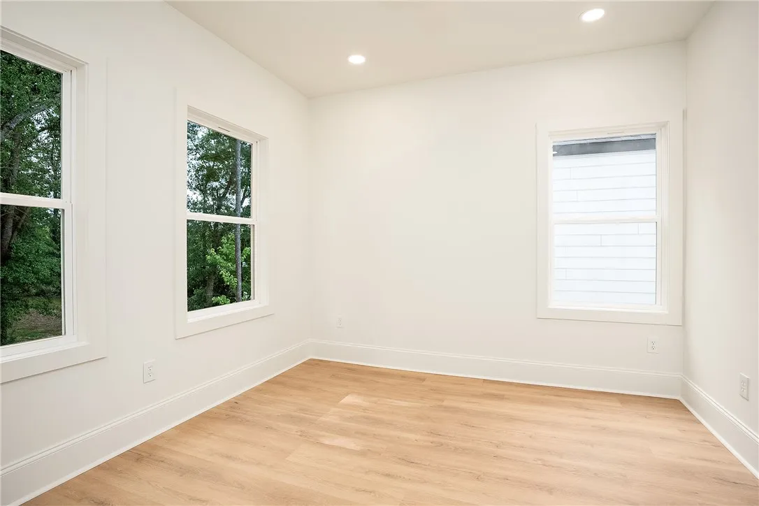 Naturally illuminated, this well-proportioned room features modern recessed lighting and durable hardwood-style flooring.