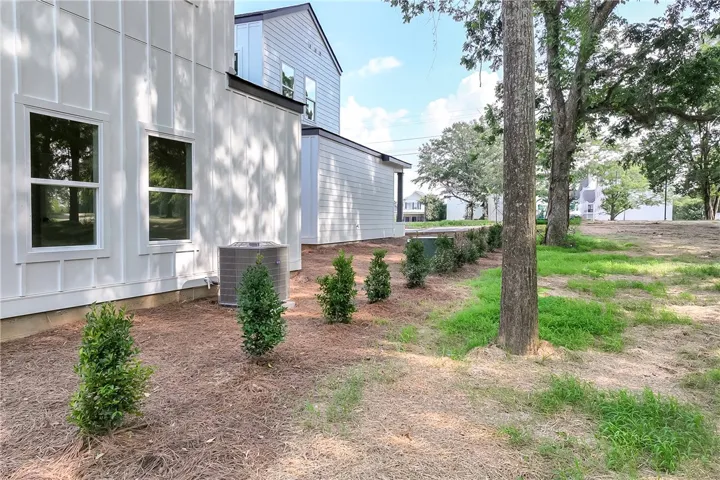 Board and batten siding graces this newly constructed home with a serene, natural backdrop.