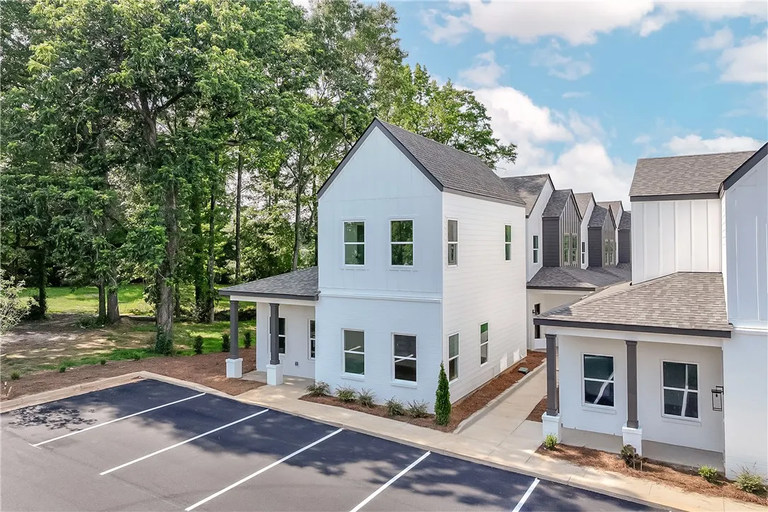 Clean lines define this newly constructed residence, offering both modern aesthetics and practical parking.