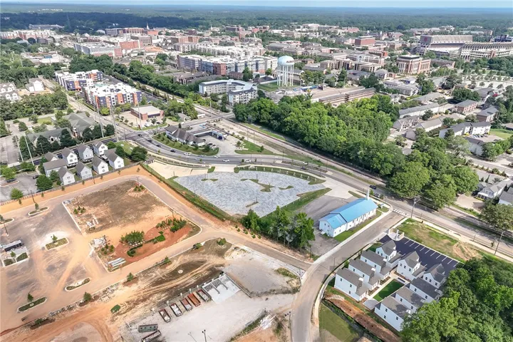 An aerial perspective reveals a vibrant community with diverse architecture, green spaces, and urban infrastructure.