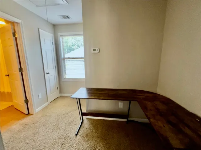 An adaptable bonus space, perfect for an office, offers soft carpeting and a window for natural light.