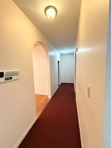 Hallway, passing dining/kitchen, leading to bedrooms 3, 4, and laundry