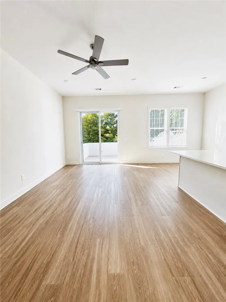 Sliding glass doors open to  spacious open-concept living area.