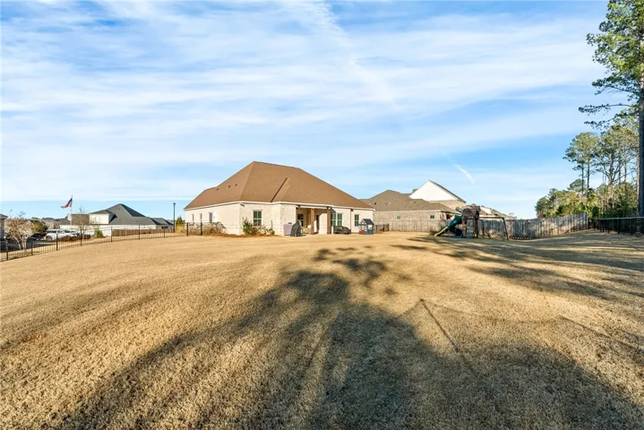 Home rests on a level, full fenced 0.5 acre lot