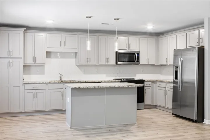 Open concept kitchen with granite countertops