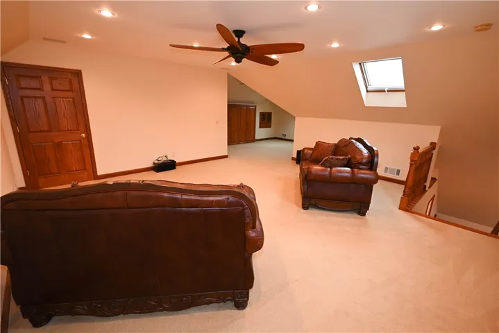 Bonus room is set up for a home theater with surround sound speakers!