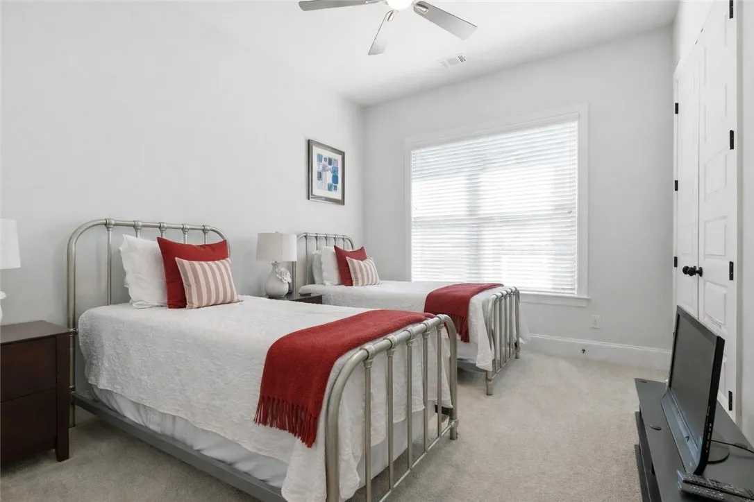 Bedroom two comfortably accommodates twin beds and enjoys direct access to bath 2—an excellent setup for guests or family.