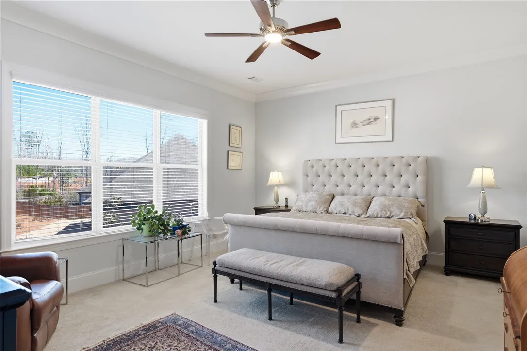 The rear-facing primary bedroom offers generous scale and three substantial windows.
