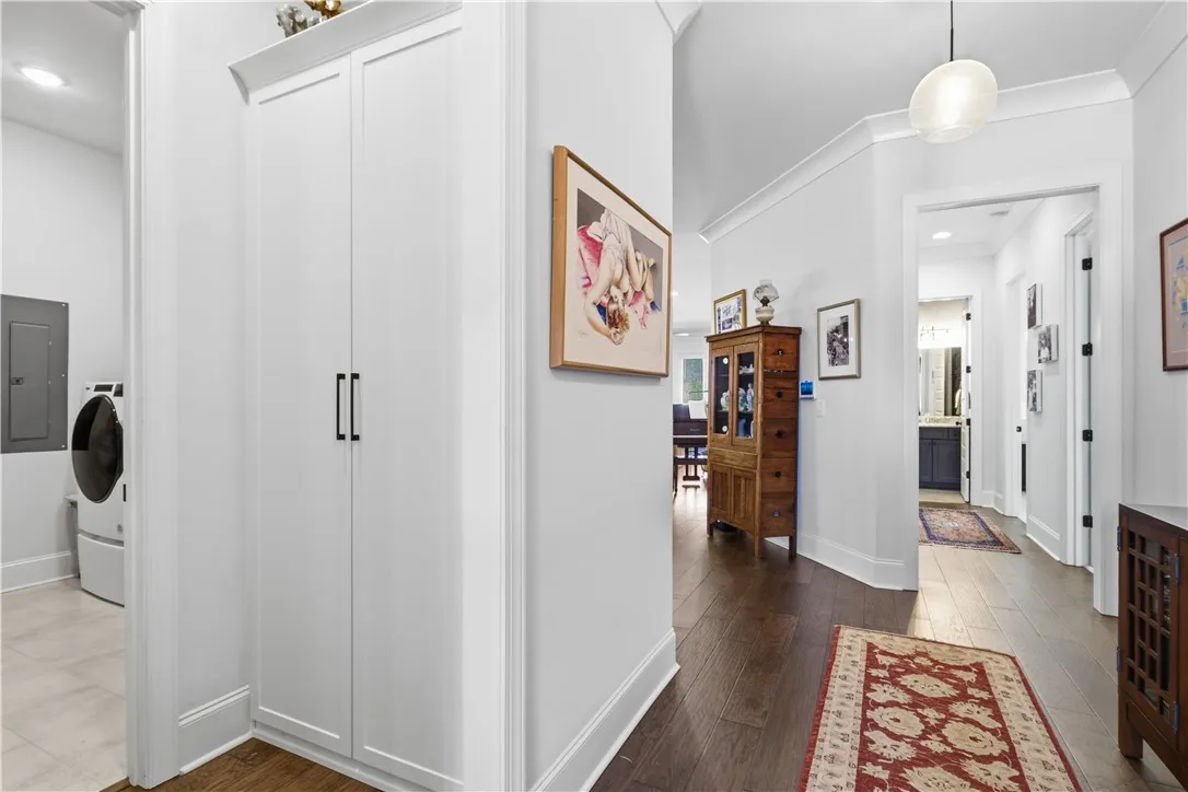 Custom cabinetry at the owner’s entry establishes a functional drop zone, with the expansive laundry and conditioned flex room positioned just beyond.
