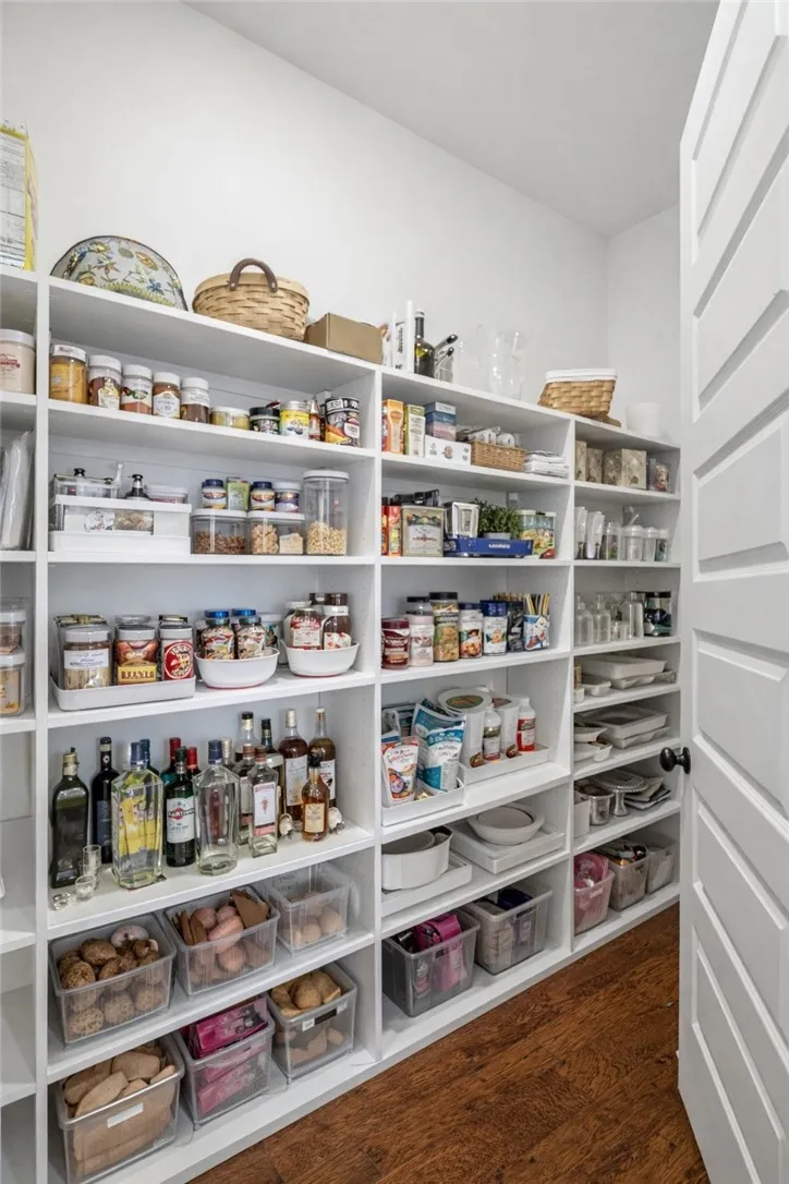 The pantry is outfitted with a custom storage system.