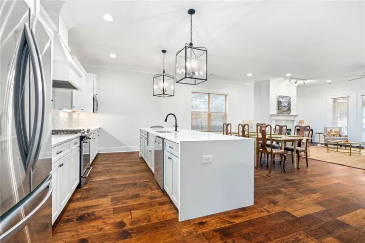 The layout promotes flow and connection between the kitchen, dining area, and living room.