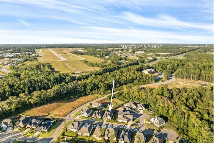 An aerial perspective showcases the neighborhood context and nearby local amenities.