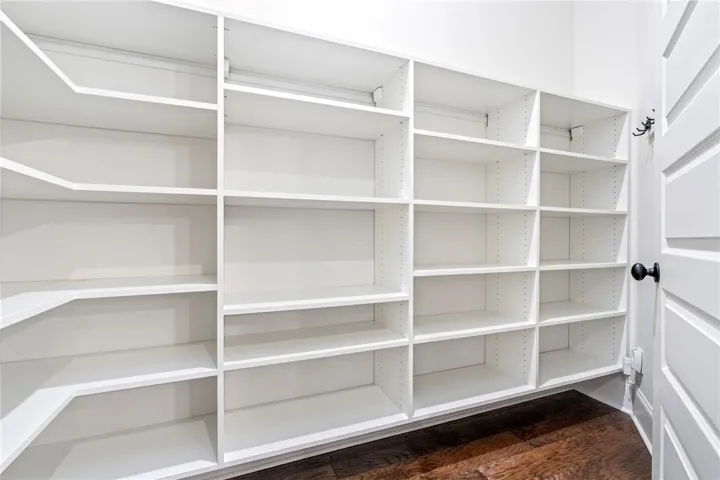 The pantry is outfitted with a custom storage system.