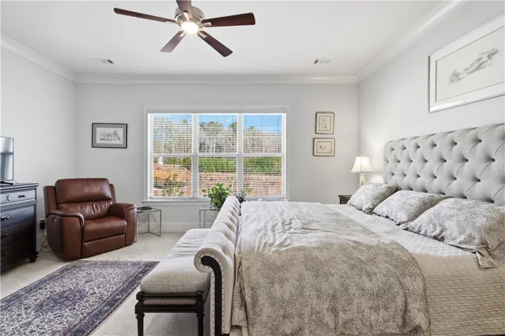 The rear-facing primary bedroom offers generous scale and three substantial windows.