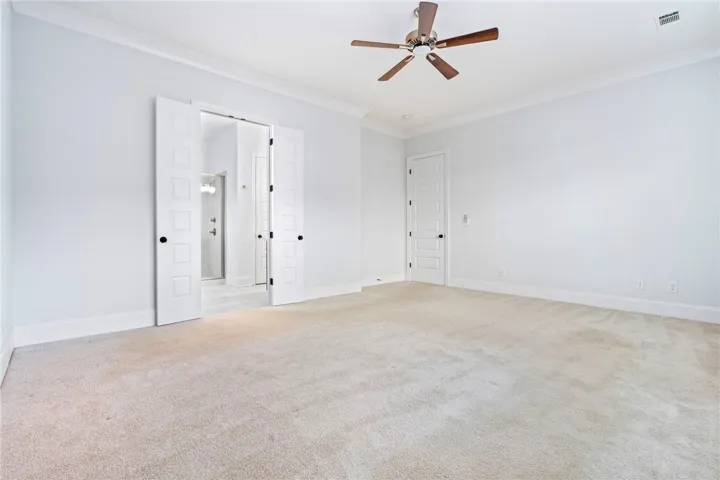 The rear-facing primary bedroom offers generous scale and three substantial windows.