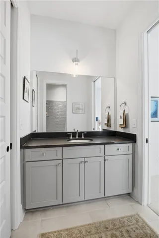 Bath three is positioned between bedrooms three and four and features an extended vanity in the main area, with a separate tub and shower room behind a door for added privacy—ideal for shared use.