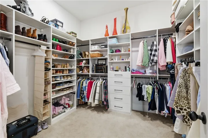 The spacious primary closet provides customized organization and generous display space.