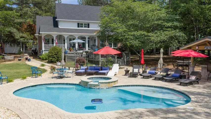 Relax and entertain in this beautiful backyard oasis featuring a pool and ample space for outdoor living.