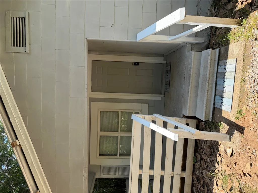 Concrete steps lead to a welcoming entry on this functional home.