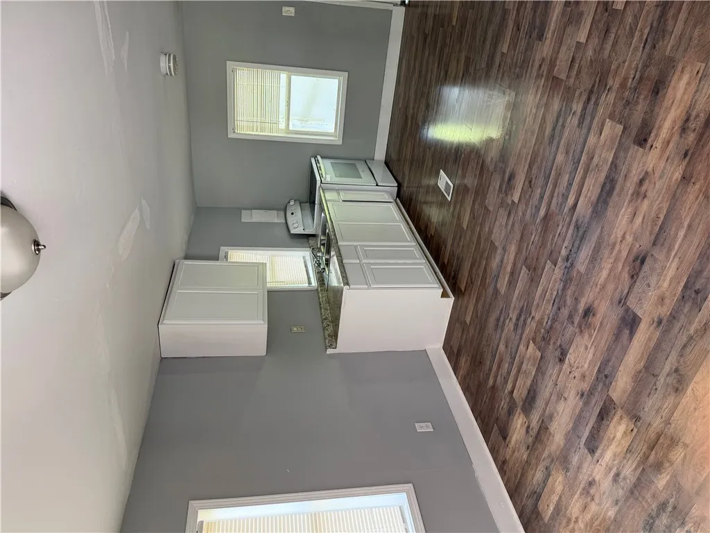 Functional kitchen with ample cabinet space, durable countertops, and sleek flooring.