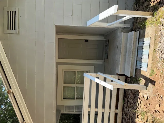 Concrete steps lead to a welcoming entry on this functional home.