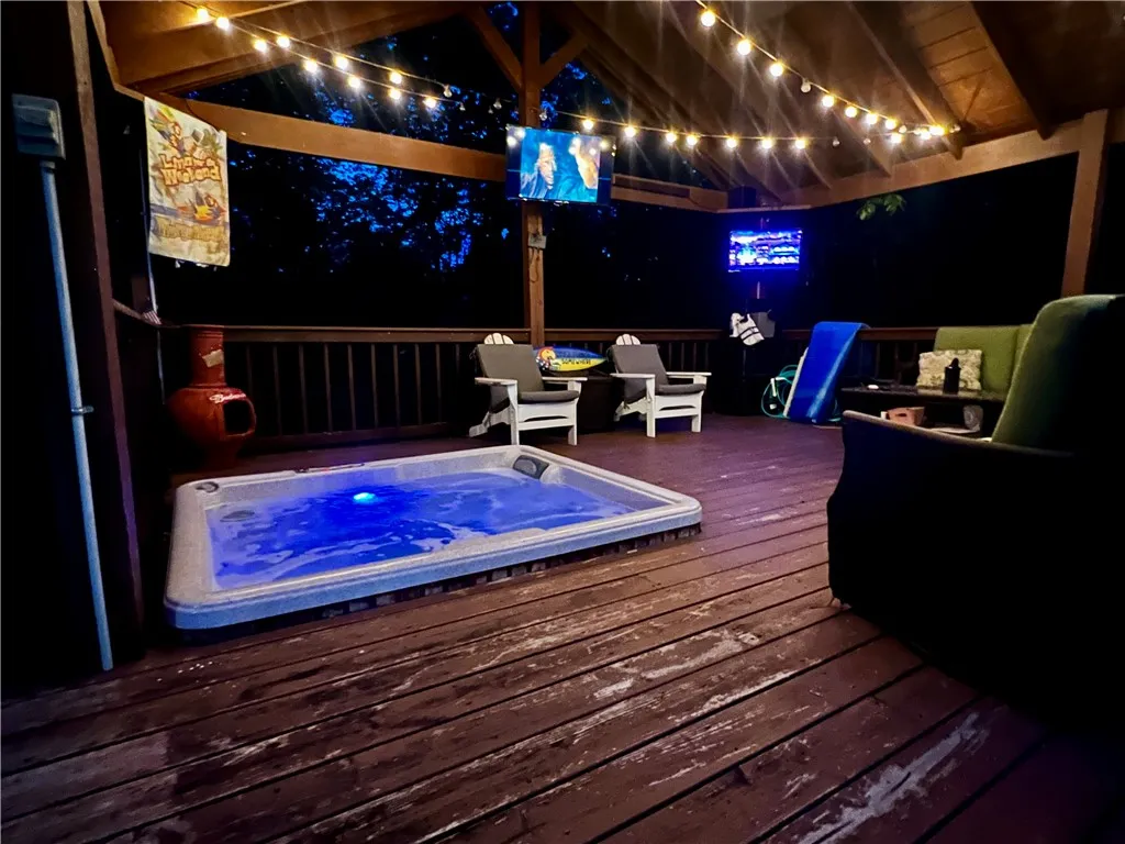 An inviting hot tub area with festive lighting creates a perfect outdoor entertainment space.