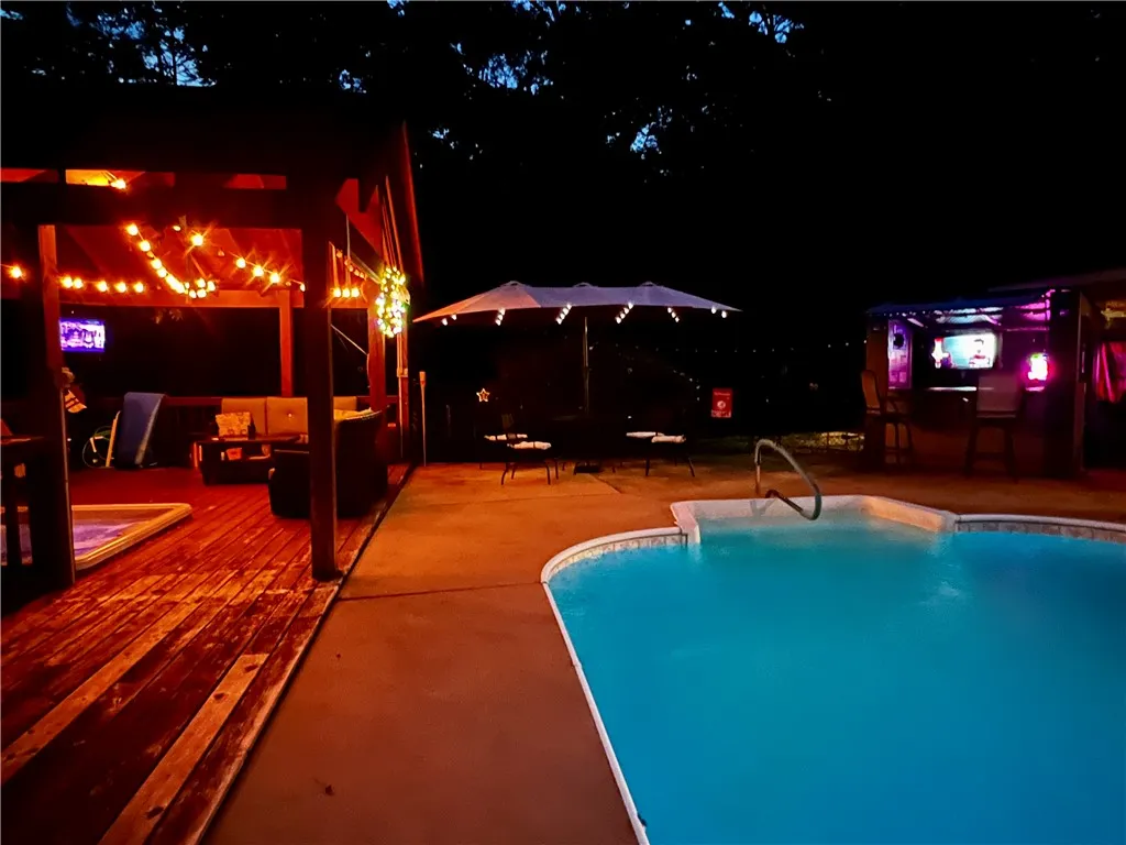 Entertain with ease on this spacious deck with a shimmering pool and a dedicated outdoor bar area.