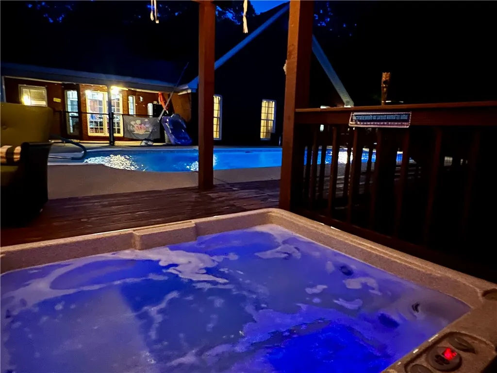 Relax in the soothing spa, enjoying the evening ambiance of the private pool area.
