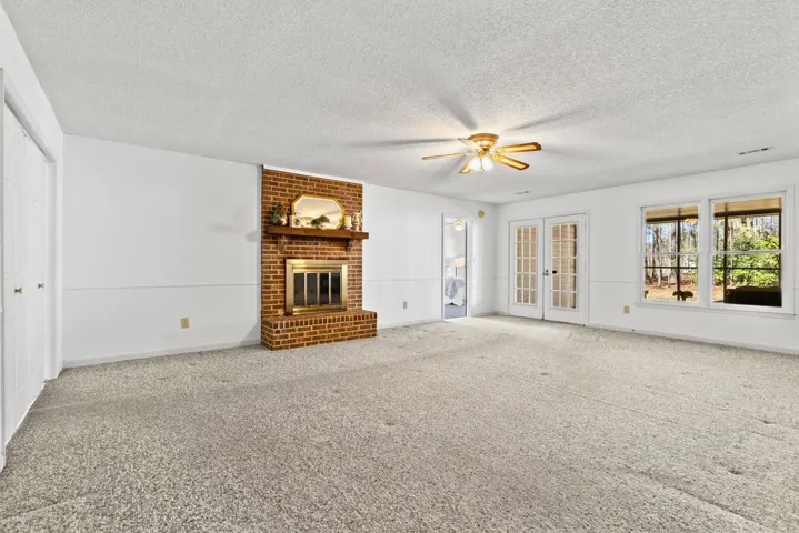 Living room and french doors lead to screened porch
