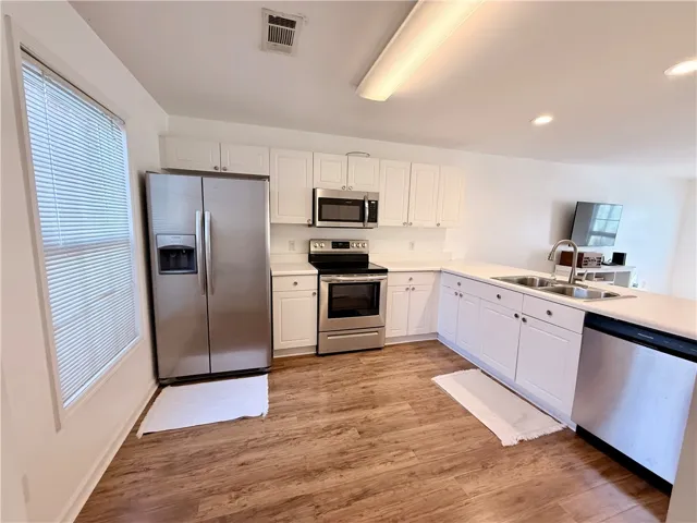 Spacious white kitchen with new appliances