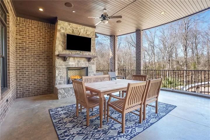 Main level patio w/ fireplace & TV