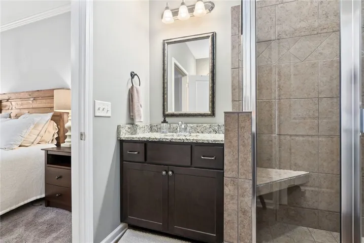 The en-suite for the Master has dual vanities and a tiled step-in shower with a bench seat.