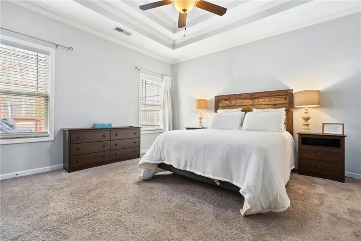 The Master Suite features a double tray ceiling, ceiling fan, two walk-in closets, and a luxurious en-suite Private Bath.
