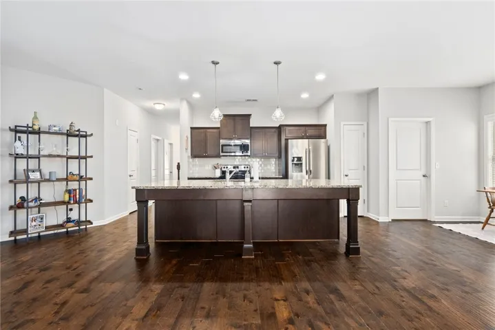 This HUGE Kitchen will be where everyone wants to be! It has a large island/breakfast bar, stainless steel appliances, granite countertops, a subway tile backsplash, a separate pantry, and is open to the Breakfast Room and Den.