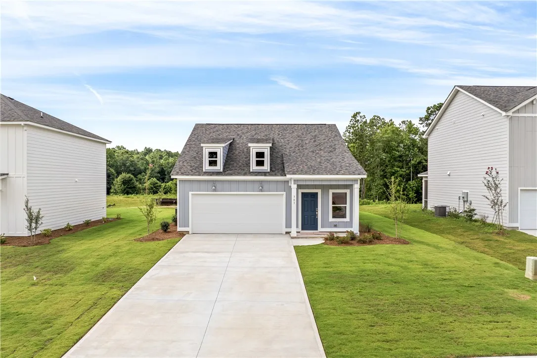 A welcoming facade features a prominent two-car garage and a neatly maintained lawn, hinting at comfortable suburban living.