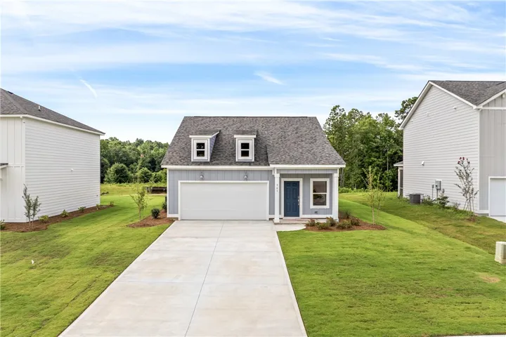 A welcoming facade features a prominent two-car garage and a neatly maintained lawn, hinting at comfortable suburban living.