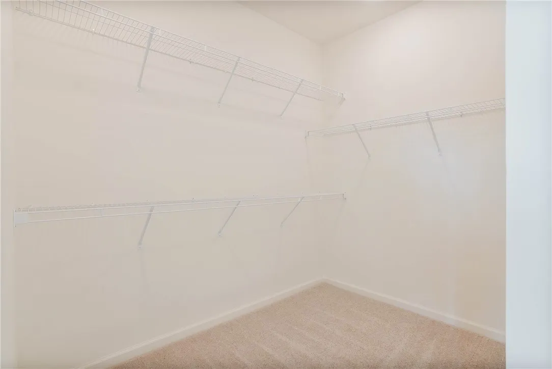 Customizable storage solutions define this practical walk-in closet.