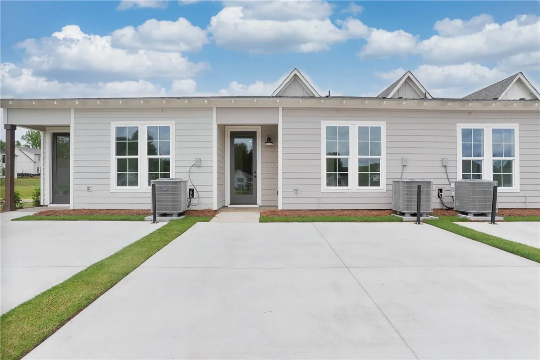 Clean lines and light siding define this modern multi-unit exterior, offering designated entryways.