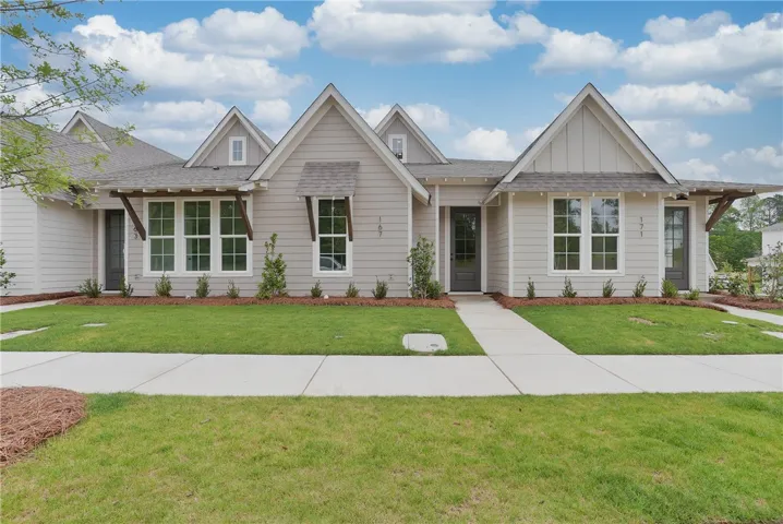 A well-kept green lawn and tidy landscaping create welcoming curb appeal for this charming single-story residence.