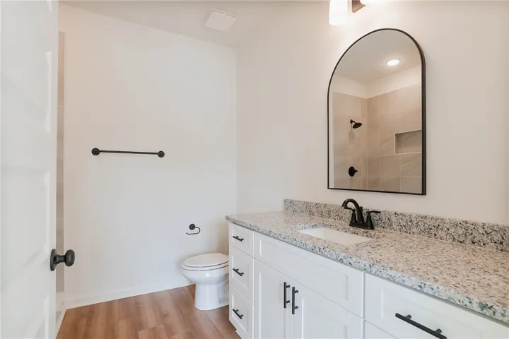 A well-appointed bathroom with a spacious vanity, toilet, and modern fixtures.